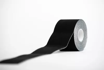 a black roll of kinesio tape.