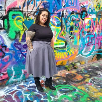 Leslie DeJesus poses for a photo in Graffitti Alley in Baltimore. 