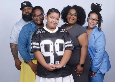Leslie DeJesus (far right) poses with her family for a picture.