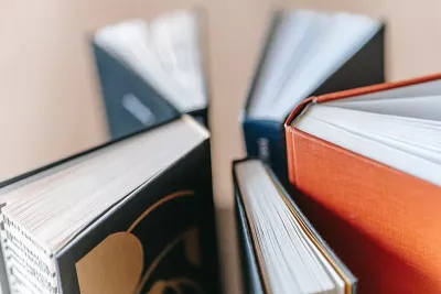 5 hardcover books spiraled out in a circle.