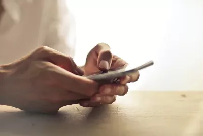 A person holds a cell phone.