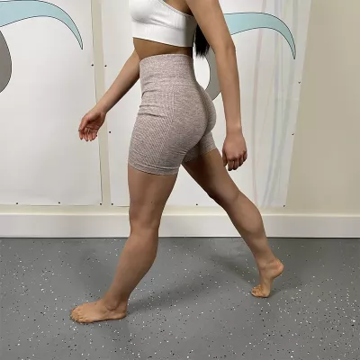 A woman demonstrating normal stride length.