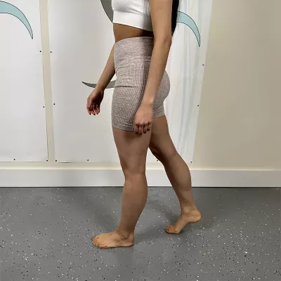 A woman demonstrating decreased stride length.