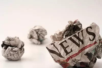 three crumpled balls of newspapers.
