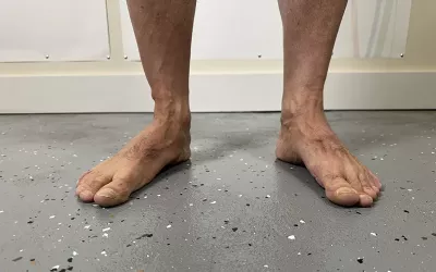 A pair of feet standing on a floor.