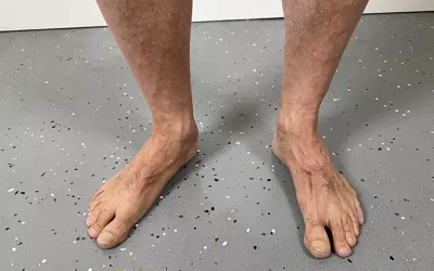 A pair of feet standing on a floor.