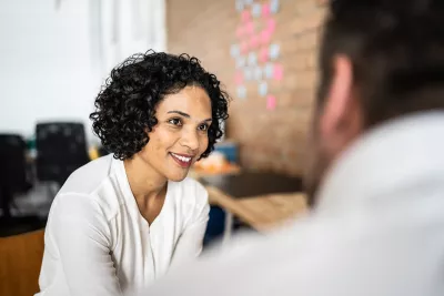 A woman and a man have a discussion.