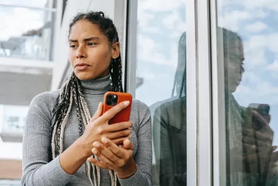 A woman holding a smartphone. 