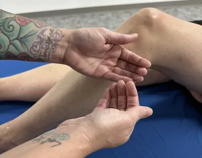 massage therapist demonstrating a release motion for massage.