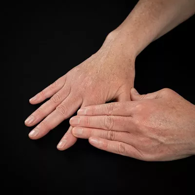 Demonstration of the exercise from Image 13 with added resistance from the free hand on the index finger.