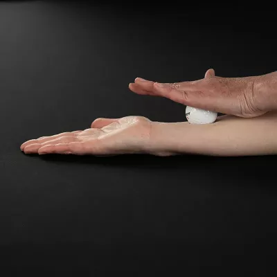 Demonstration of massaging the forearm by pressing a golf ball with the palm of the opposite hand into the forearm.