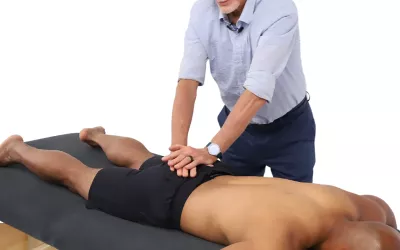 Massage therapist Erik Dalton demonstrates sacral roll.