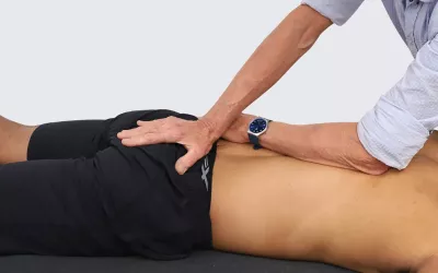 Massage therapist Erik Dalton demonstrates sacral base decompression.