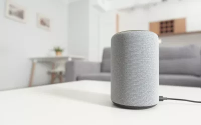 An audio speaker sits on a table in a home environment.