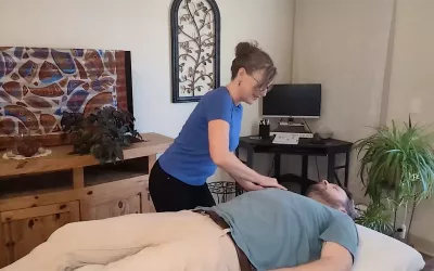 Cindy Williams demonstrates vibration technique on a male client.