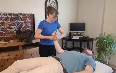 Cindy Williams demonstrates swinging technique on a male client.