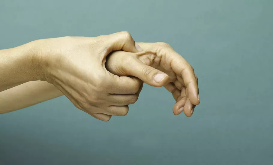 Self-massage of right hand on the left hand's thumb. 
