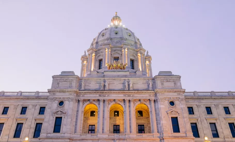 The Minnesota state capitol lit up at dusk.