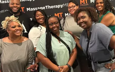 Attendees at the inaugural Black Massage Therapist Conference smile for a photo.