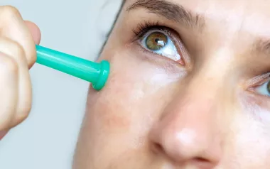 Close up of a women's cheek with a small cupping tool in place.