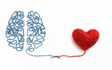 blue threads make the shape of a brain that lead to red threads that form the shape of a heart.