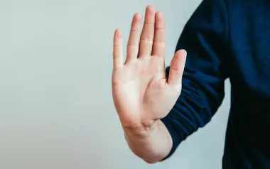 a hand raised up, making a stop gesture. 