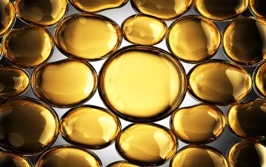 Futuristic, shiny gold globules filled with an oily substance.