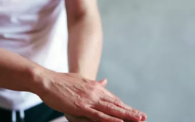 A practitioner lays hands on a client.