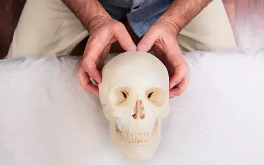 An MT demonstrates the parietal technique on a skull. 
