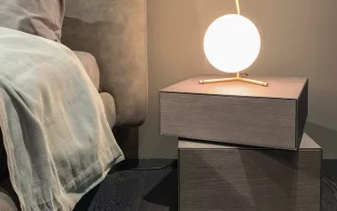 a tranquil room with a bed and globe-shaped floating lamp giving off soft light.