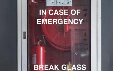 A glass fire case reads "in case of emergency break glass".