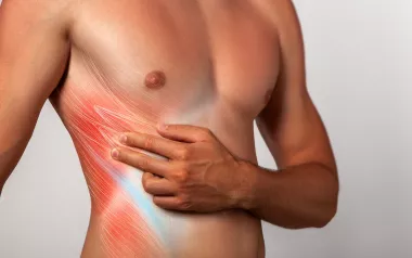 A male figure pulls hands and fingers across his transversus abdominis muscles.