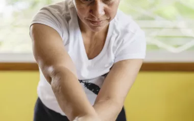Woman massages the leg of a client. 