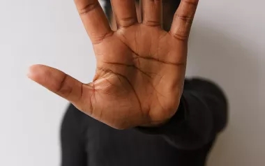 Man holding hold up to demonstrate stopping. 