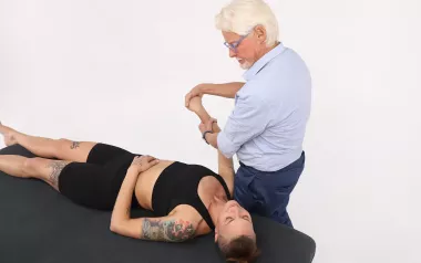 Massage therapist Erik Dalton massages a client's right arm.