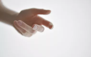 a person's hand reaching outward.