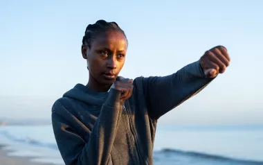 A woman throws a punch.