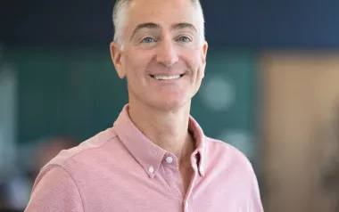Portrait image of Darren Buford in a pink button-down shirt.