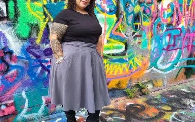 Leslie DeJesus poses for a photo in Graffitti Alley in Baltimore. 