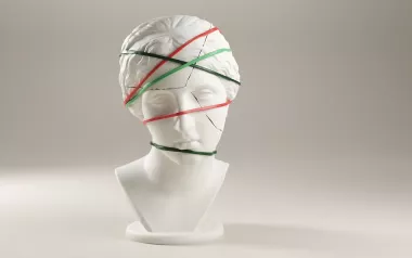 A cracked statue bust with bands around it holding it together.