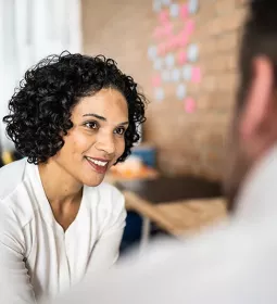 A woman and a man have a discussion in a professional mentor relationship.