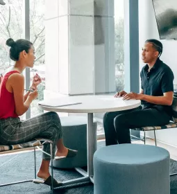 A man and woman conducting a job interview in an office setting.