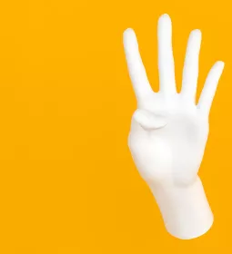 A hand displays the number four.