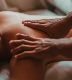 Two hands of an MT on a person's back.