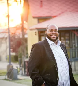 portrait of Terrance Bonner in a black suit jacket and white shirt.