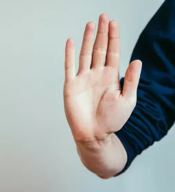 a hand raised up, making a stop gesture.