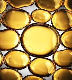 Futuristic, shiny gold globules filled with an oily substance.