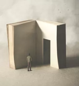 A conceptual image of a person looking at a book or story with a doorway in a page..