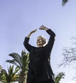 MT Lee Hodges stretching upwards and smiling.