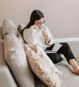 an adult looking over notes thinking about what they are reading.